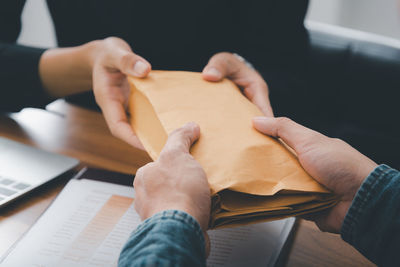 High angle view of woman hand holding paper