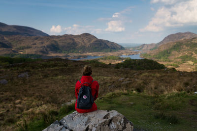 Rear view of man on landscape against sky