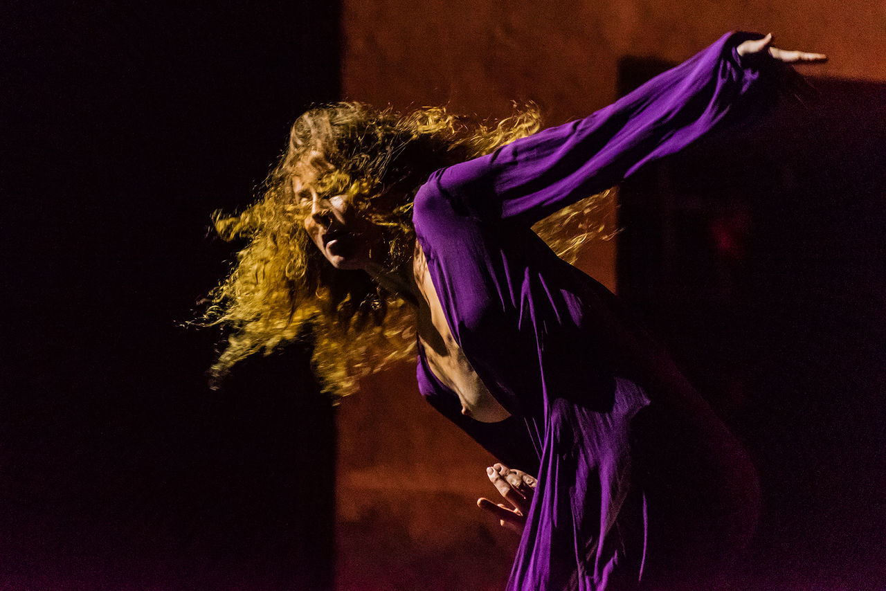 one person, indoors, women, hair, hairstyle, adult, clothing, dancing, studio shot, purple, side view, long hair, performance, fashion, arts culture and entertainment, standing, lifestyles, real people, night, obscured face, beautiful woman