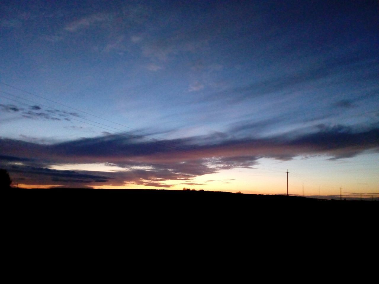 silhouette, landscape, tranquil scene, scenics, sunset, tranquility, outline, sky, dark, beauty in nature, calm, nature, dusk, cloud, cloud - sky, majestic, outdoors, horizon over land, blue, moody sky, dramatic sky, non-urban scene, remote, no people, atmosphere, cloudy, atmospheric mood, cloudscape, multi colored