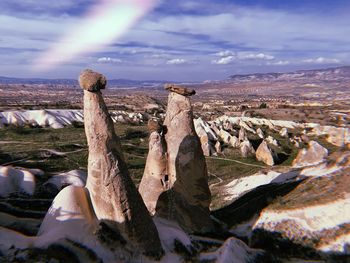 Panoramic view of rock formations on landscape against sky