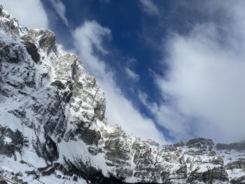 Low angle view of snowcapped mountain against sky