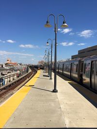 Train at railroad station against sky