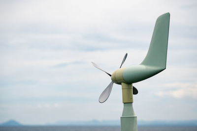 Low angle view of wind turbine against sky