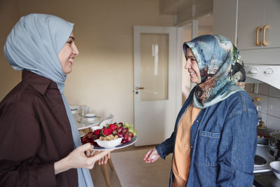 Women in headscarves preparing healthy snacks at home