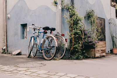 Bicycle parked on street by building