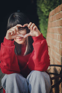 Portrait of young woman sitting outdoors