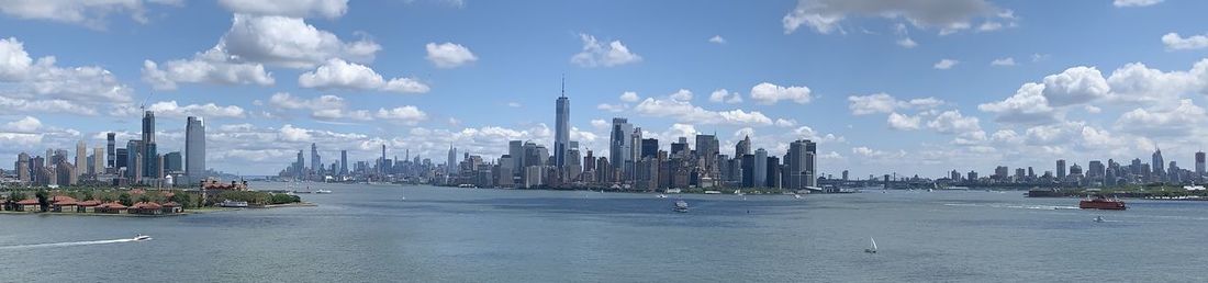 Panoramic view of sea and buildings against sky
