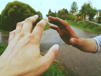 Close-up of people hand touching mirror