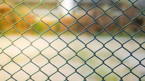 Full frame shot of chainlink fence against field