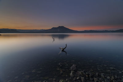 Scenic view of lake against sky during sunset