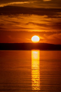 Scenic view of sea against orange sky