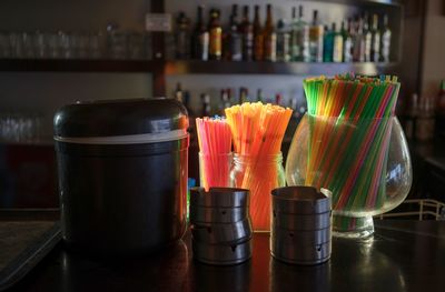 Close-up of drinking straw in jars on table