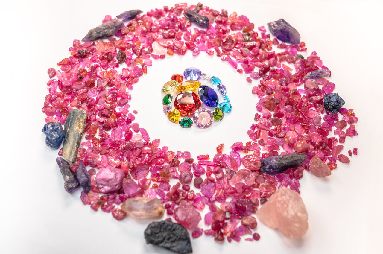 HIGH ANGLE VIEW OF MULTI COLORED CANDIES ON TABLE