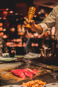 Close-up of hand pouring wine in glass