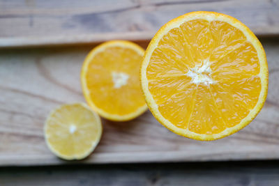 Close-up of oranges and lemon on table