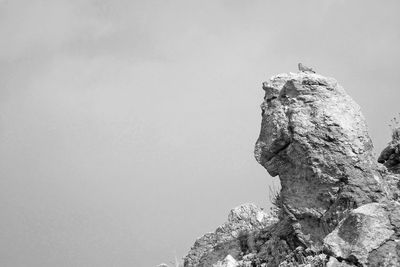 Low angle view of rock formation against clear sky