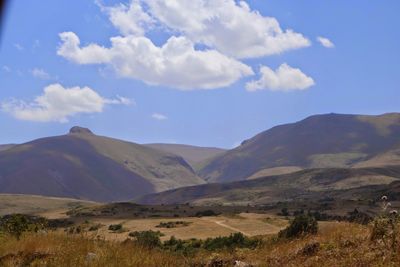 Scenic view of mountains against blue sky