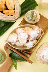 Close-up of fried coconut served on table