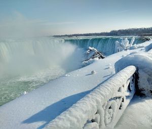 Scenic view of frozen lake against sky during winter