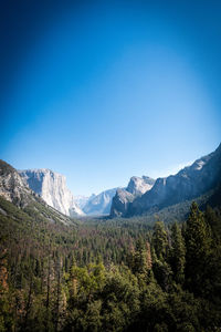 Scenic view of mountains against clear blue sky