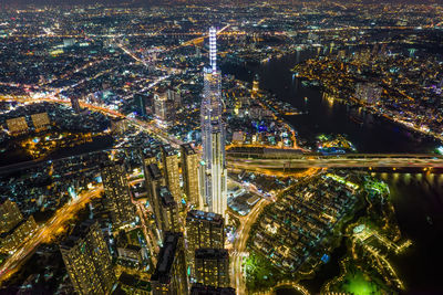 High angle view of illuminated modern buildings in city at night