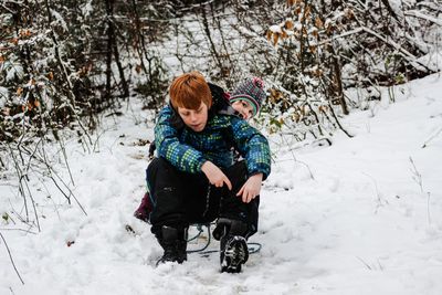 Boy playing on snow field