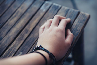 Cropped image of woman hand on table