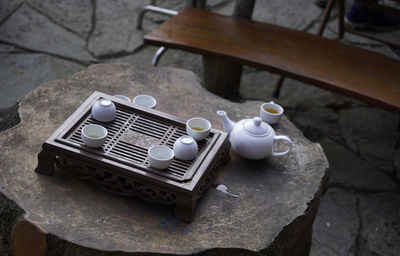 Simple tea set on a wooden tray and wood trunk table