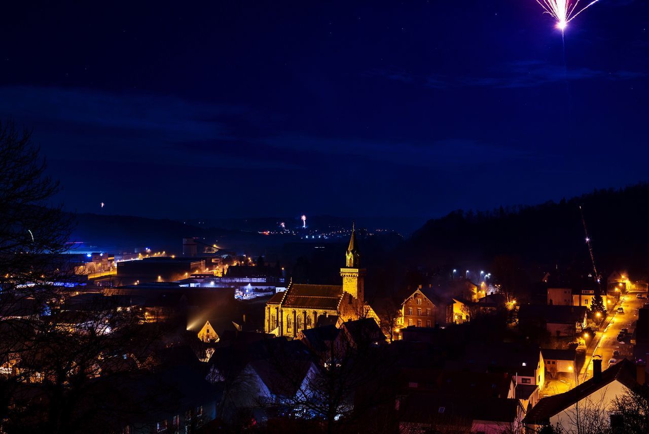 ILLUMINATED BUILDINGS AGAINST SKY AT NIGHT