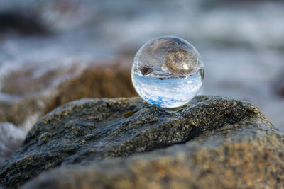 Close-up of crystal ball on rock