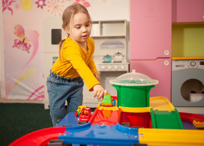 Portrait of boy playing with toys at home