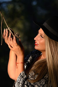 Midsection of woman holding hat