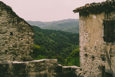 Scenic view of old building and mountains against sky