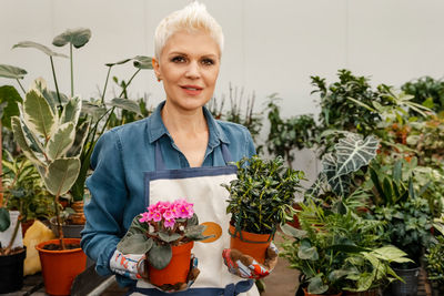 Woman holding succulent plant. woman in a greenhouse holds a pot