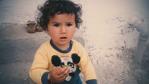 Portrait of cute boy eating ice cream outdoors