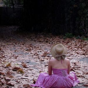 Rear view of girl sitting in autumn