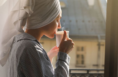 Midsection of woman drinking glass