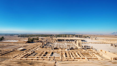 Aerial view of persepolis, ancient capital of persian empire against clear blue sky