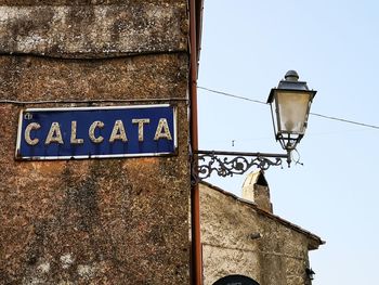 Low angle view of street light against building