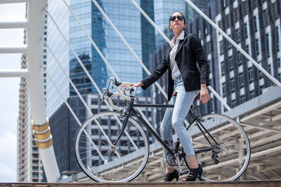 Young man riding bicycle in city
