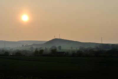 Scenic view of field against sky at sunset