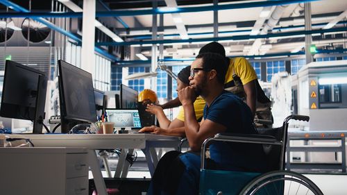 Side view of young woman using mobile phone in cafe