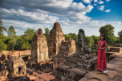 Beautiful thai girl on the top of the pre rup temple site among the ancient ruins of angkor wat