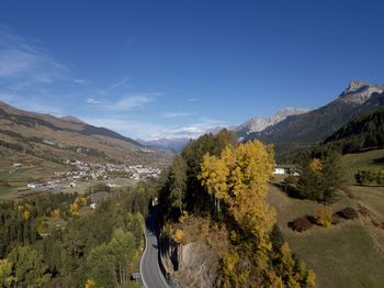 Panoramic view of landscape and mountains against blue sky
