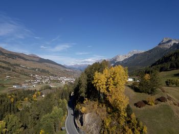 Panoramic view of landscape and mountains against blue sky
