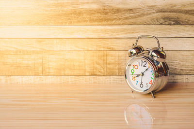 Alarm clock on wooden table