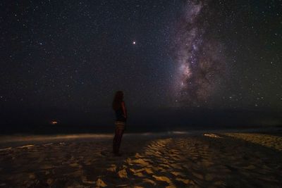 Full length rear view of man standing against sky