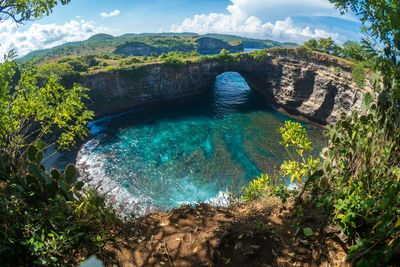 Rock coastline. stone arch over the sea. broken beach, nusa penida ,indonesia