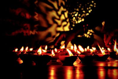 Illuminated candles burning at night